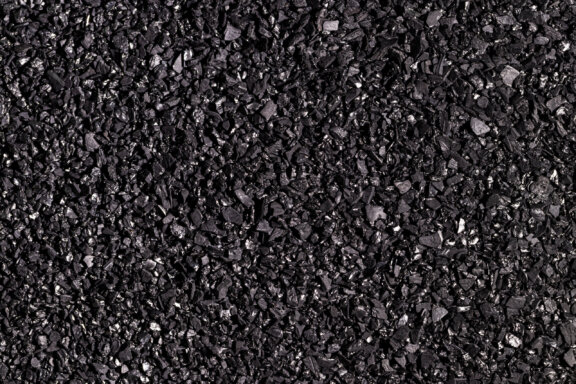 Close-up of black activated carbon texture. Coconut charcoal.