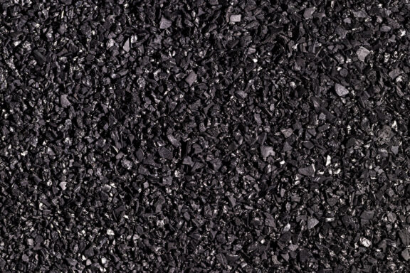 Close-up of black activated carbon texture. Coconut charcoal.