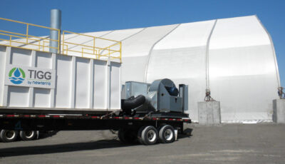A portable Nixtox vapor adsorber is loaded on a trailer near a fabric building in an outdoor setting