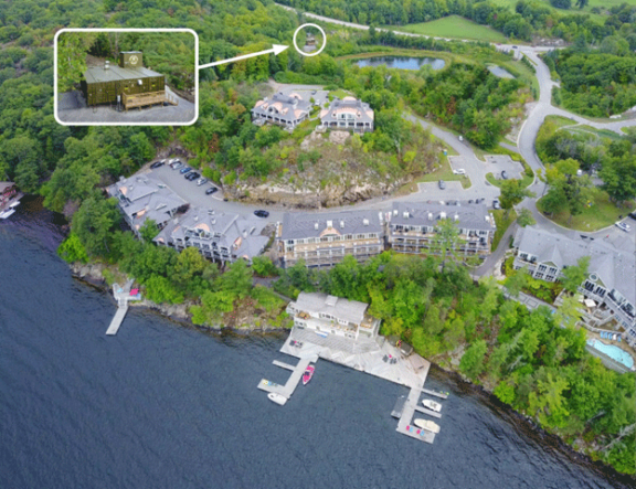 Aerial view of a waterfront residential development area with seven multiunit condominiums with a closeup image of a Newterra technology in use nearby