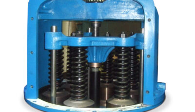View of a multiport relief valve with access panel removed, interior consists of a blue cast metal piece supported by various metal rods, some with springs bolted to the cast metal piece, a threaded rod runs through the center of unit
