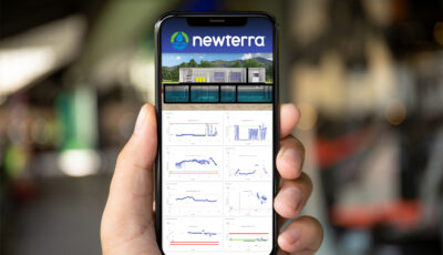 Newterra's Scada application is shown on a mobile device held by  person's left hand