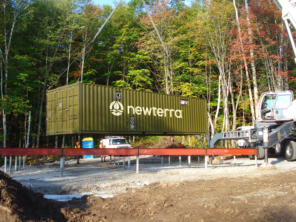 A modular water treatment system being hoisted into place