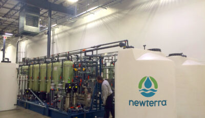 Newterra technician inspects reverse osmosis industrial water treatment equipment