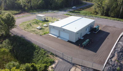 Aerial image of a steel sided building with white automatic doors