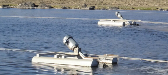 Float mounted aerators in the middle of a basin.