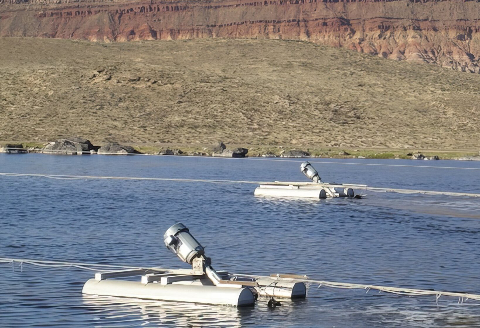 Float mounted aerators in the middle of a basin.