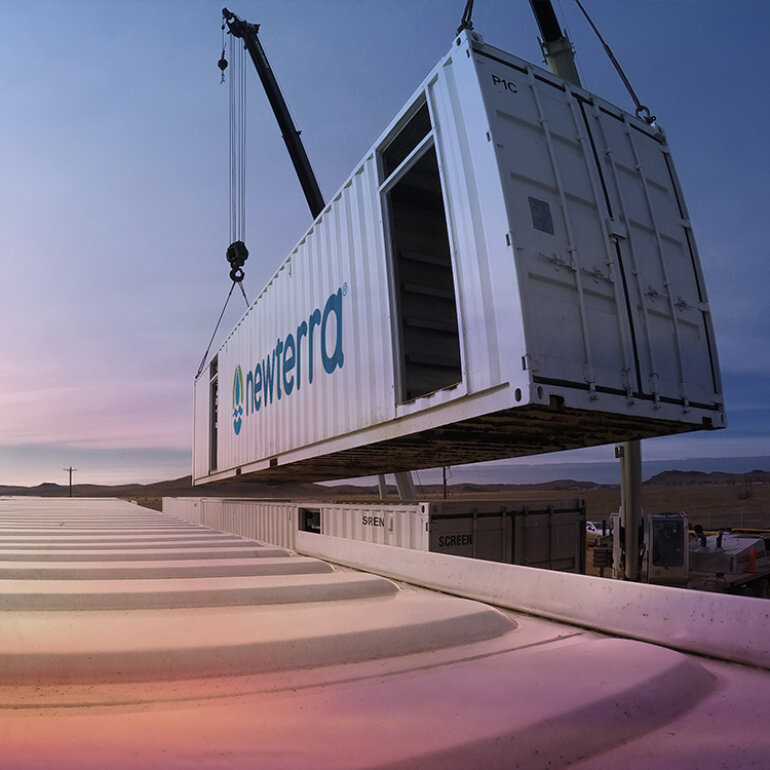 Newterra water treatment containers being lowered into place as part of a larger modular system installation